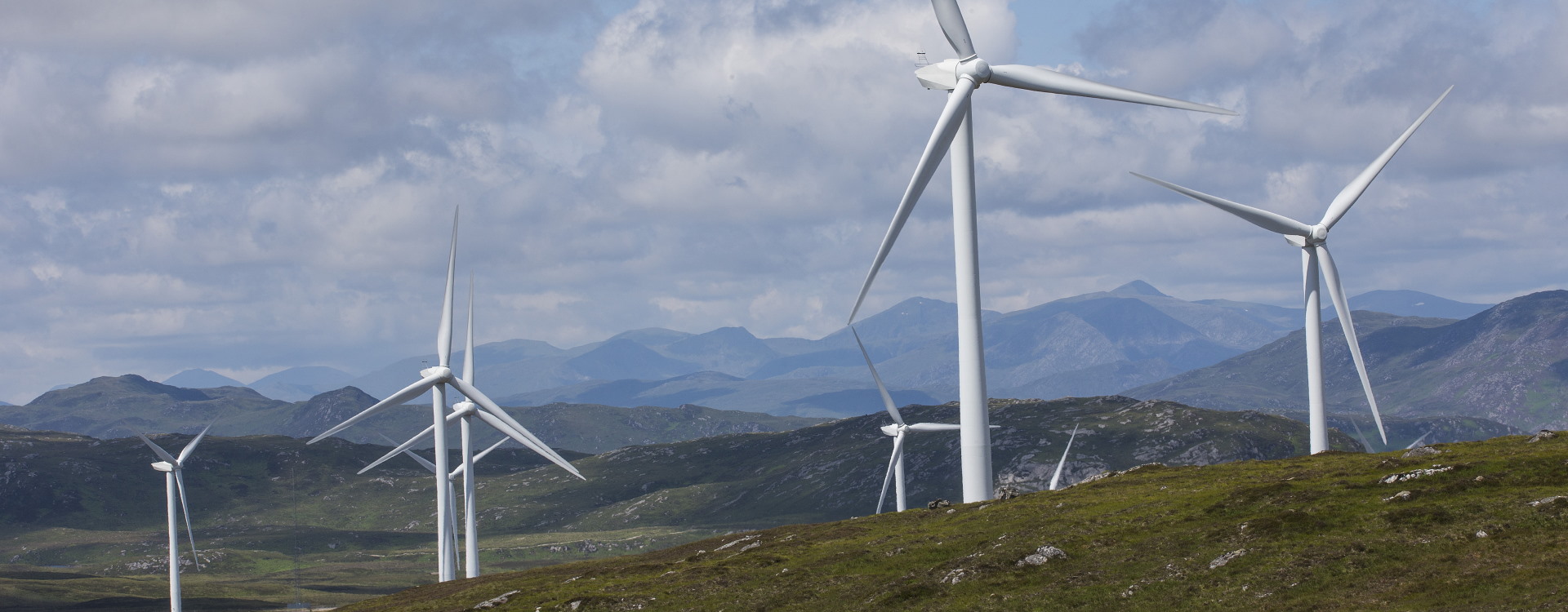 Large wind turbines on hillside of heather at Glen Orin