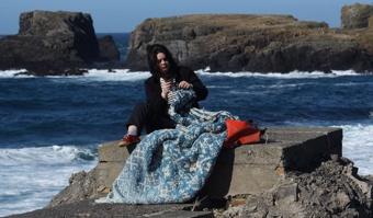Marie sitting on rock knitting