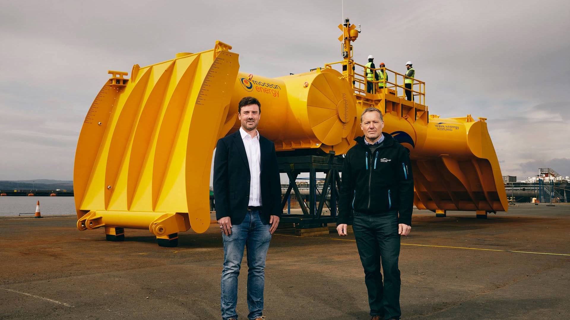 Tim Hurst in front of yellow tidal device