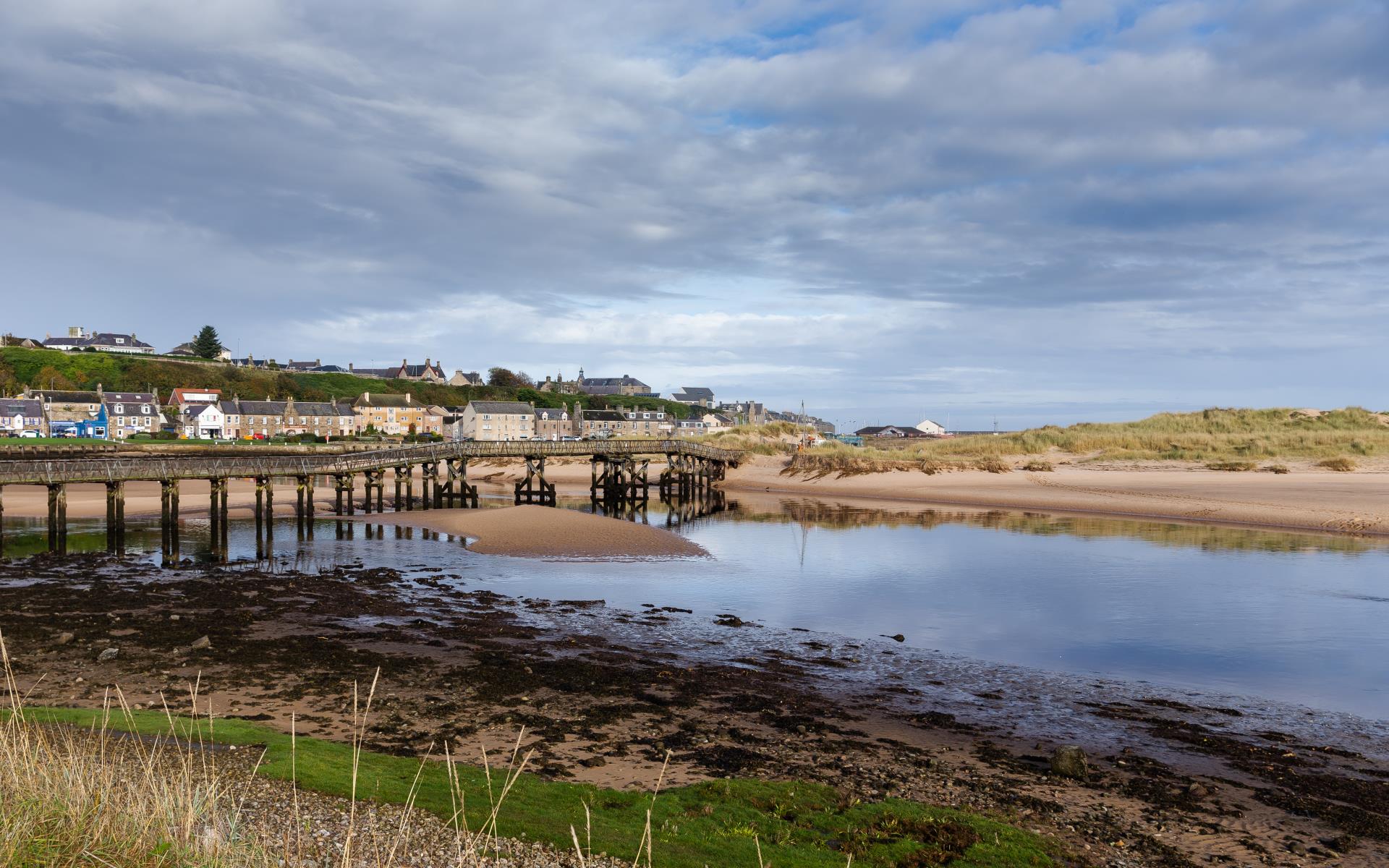 Blue waters of Lossiemouth harbour and beach