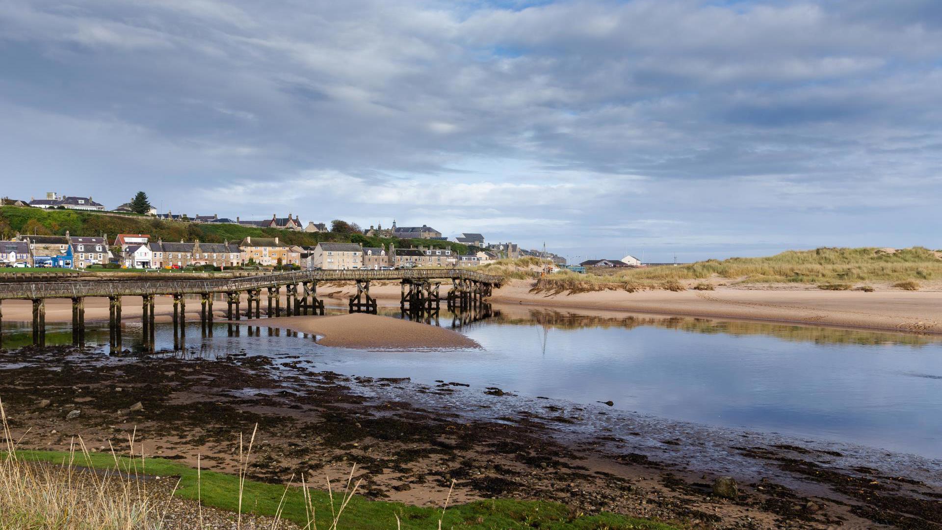 Blue waters of Lossiemouth harbour and beach