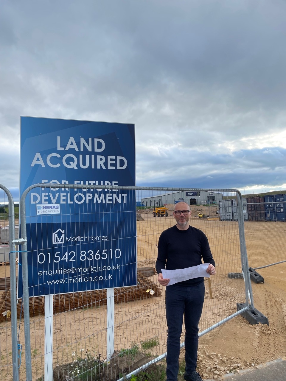 Man in front of building site