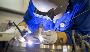 A man soldering at JGC in Caithness