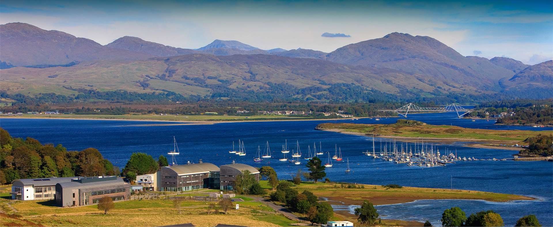 European marine science park amidst surrounding waterfront with boats in the distance.