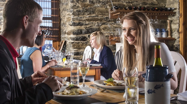 A man and woman enjoying a meal at the Captain's Galley seafood restaurant, Scrabster, Caithness, Highlands of Scotland