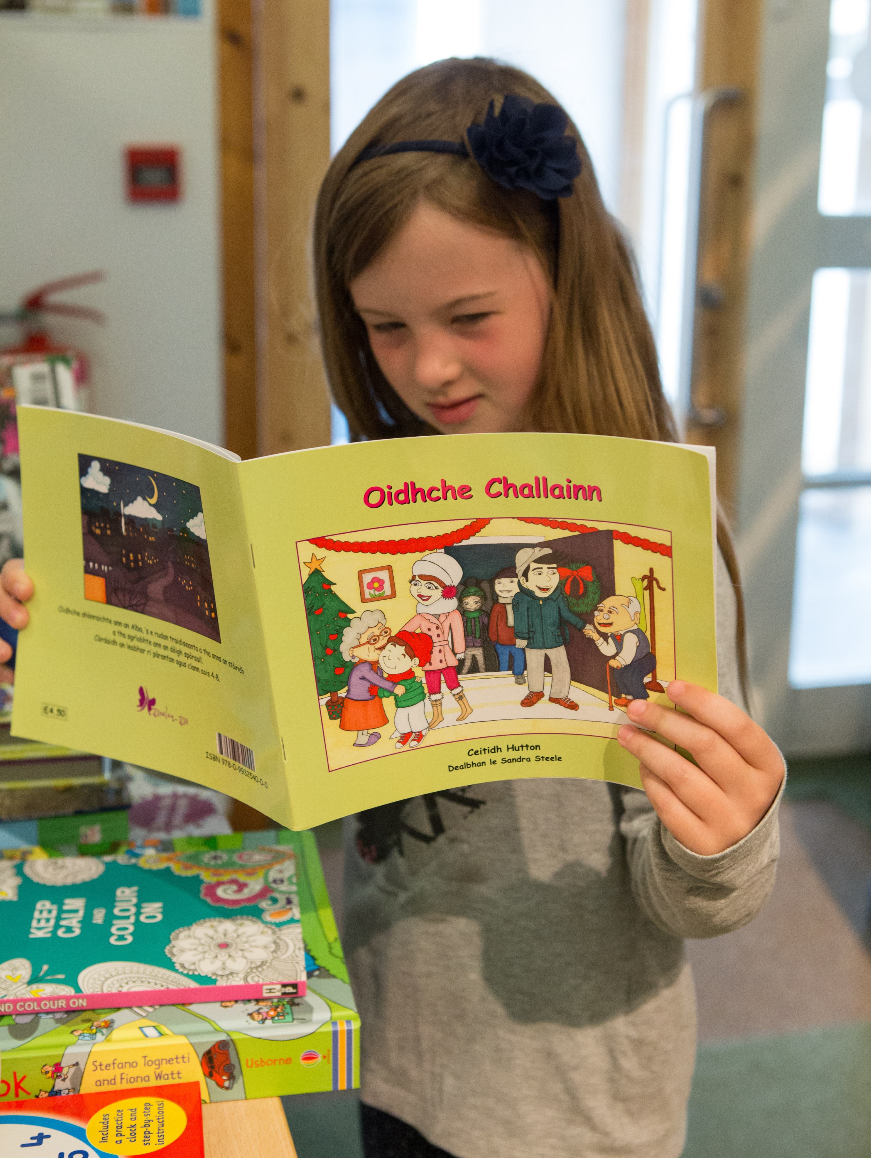 Girl reading Gaelic book 